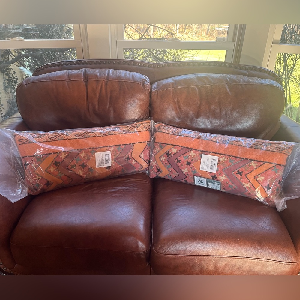 A pair of Bohemian pillows made by Karma Living in peach with embroidery